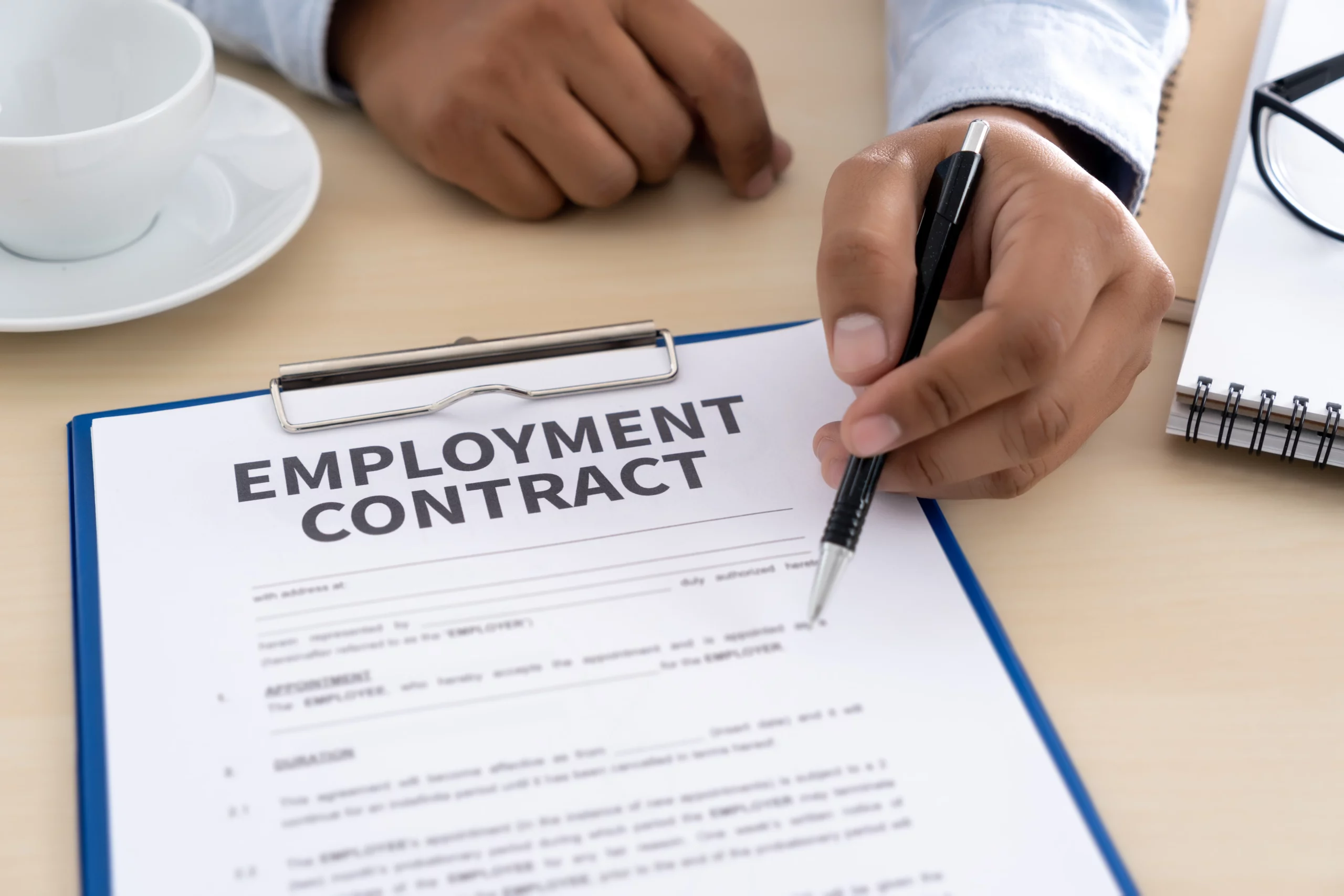 an employer giving an fixed term contract outlining the employment particulars to a potential employee.