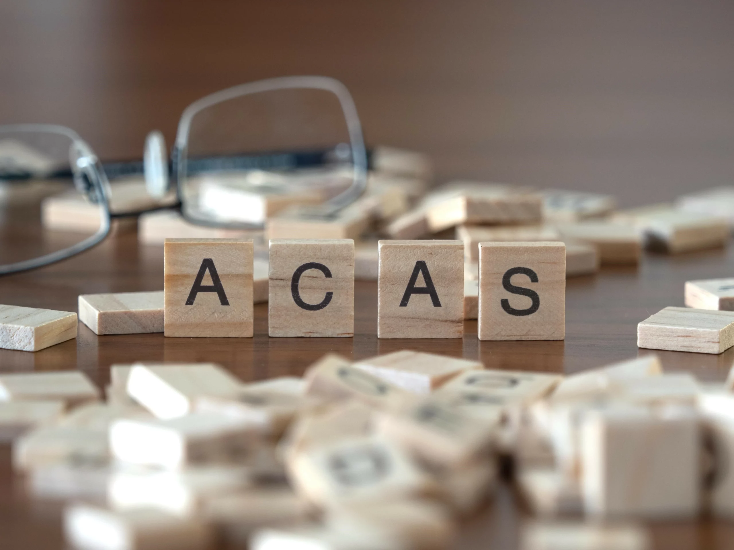 ACAS letters with a pair of glasses 