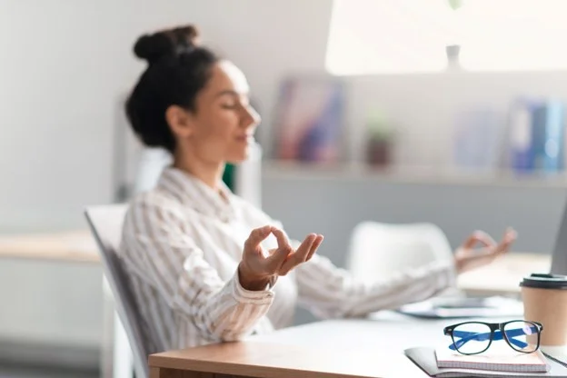 An employee experiencing good mental well-being due to workplace measures for stress prevention put in place by her employer. 