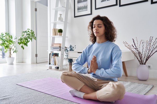 photo of a woman doing yoga promoting good mental health to prevent serious mental illness