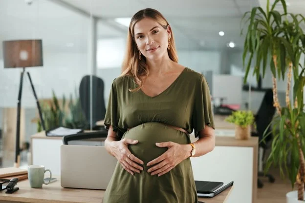 A pregnant woman whose employment status is that of an employee getting ready to take maternity leave