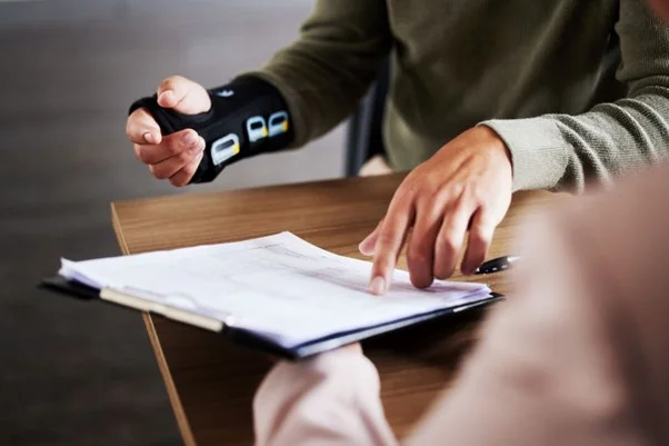 A person holding a device to a person's hand