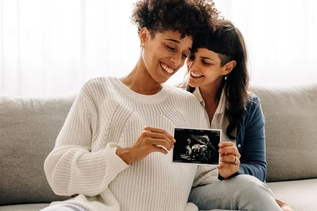 two women in a same sex couple using shared parental leave whilst being protected from maternity discrimination. 