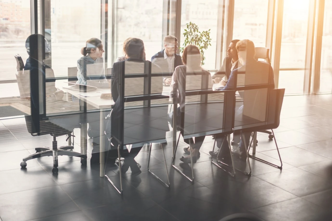 a meeting happening around a big table to discuss employment disputes to gain an early conciliation certificate. 