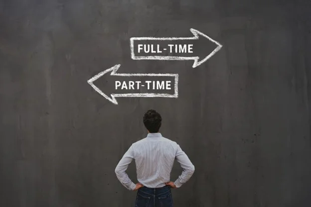 A person looking at a blackboard with arrows pointing at the same direction