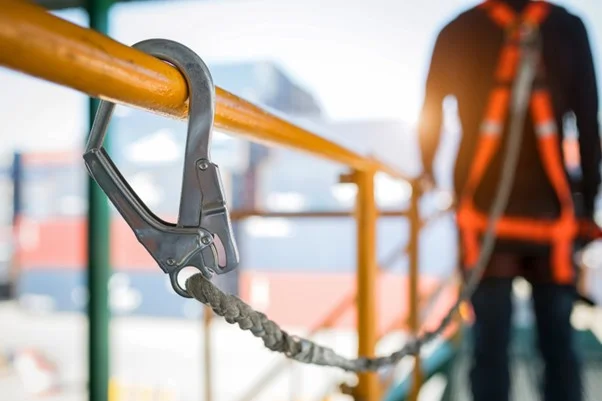 photo of a worker wearing a safety harness in line with their employer's duty to uphold health and safety regulations.