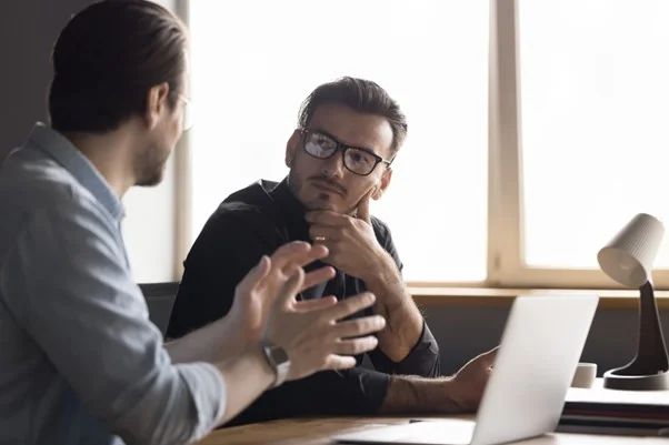 Employer listening to an employee regarding work related concerns following a risk assessment. 