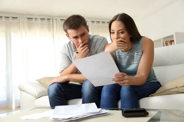 couple reading a letter of concern sent by an employer to try and encourage better employee conduct. 