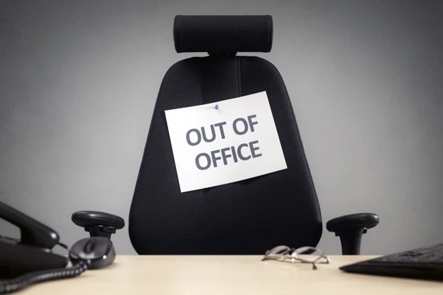 Empty desk of employee taking unauthorised time off from the team to attend a sports event.