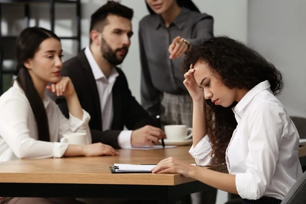 a group of workers responsible for bulling a female co-worker during a tournament event.